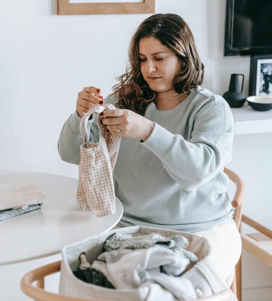 woman folding laundry in laundry room