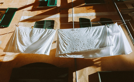 white sheets hanging on clothes line